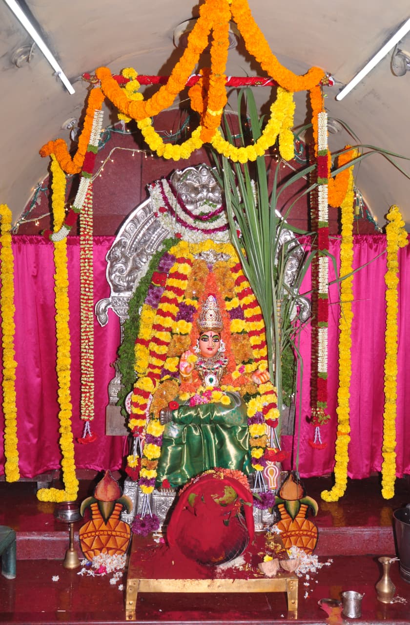 Temple deity beautifully decorated with flowers and traditional ornaments