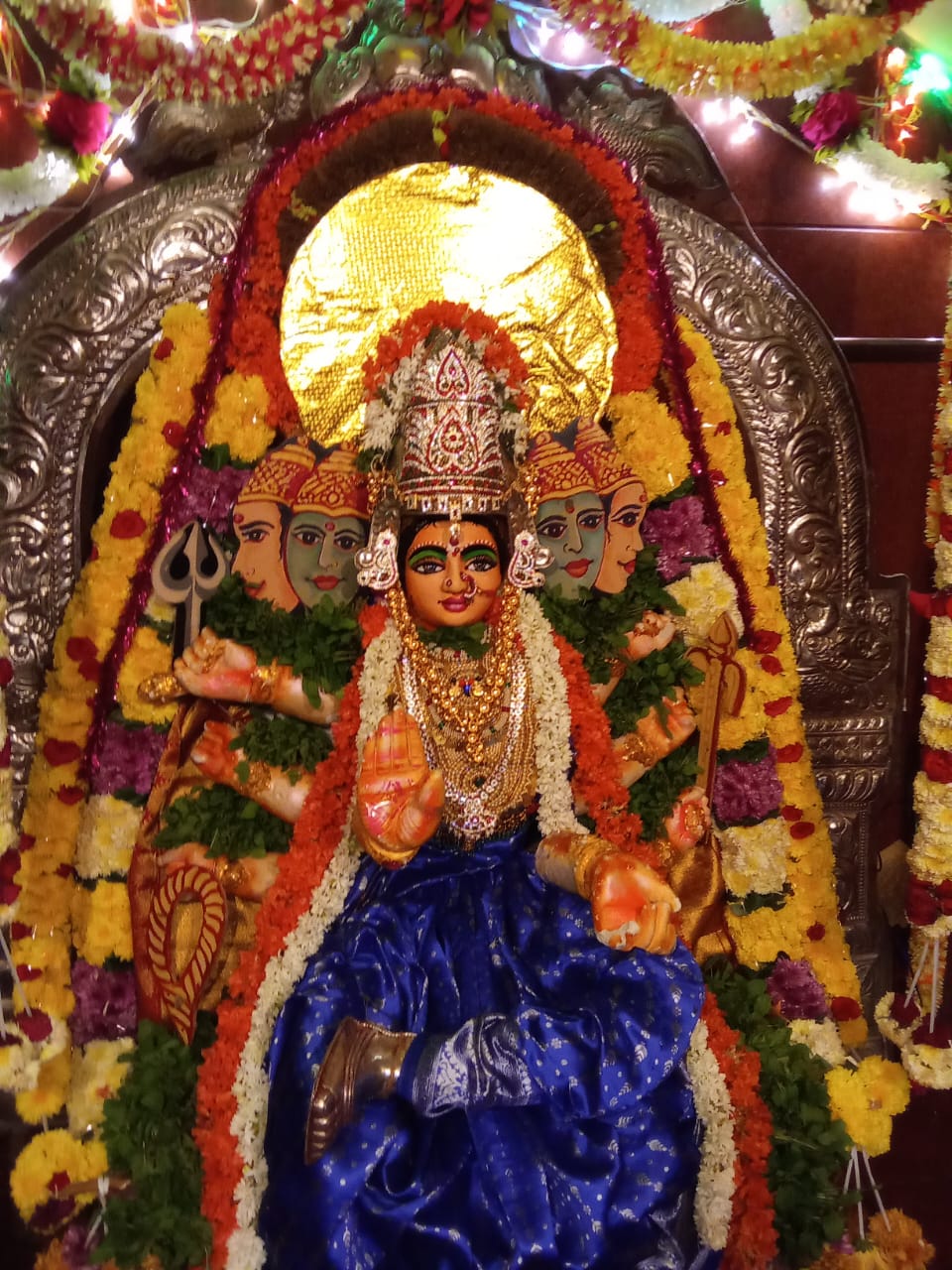 Decorated goddess shrine with traditional floral arrangement