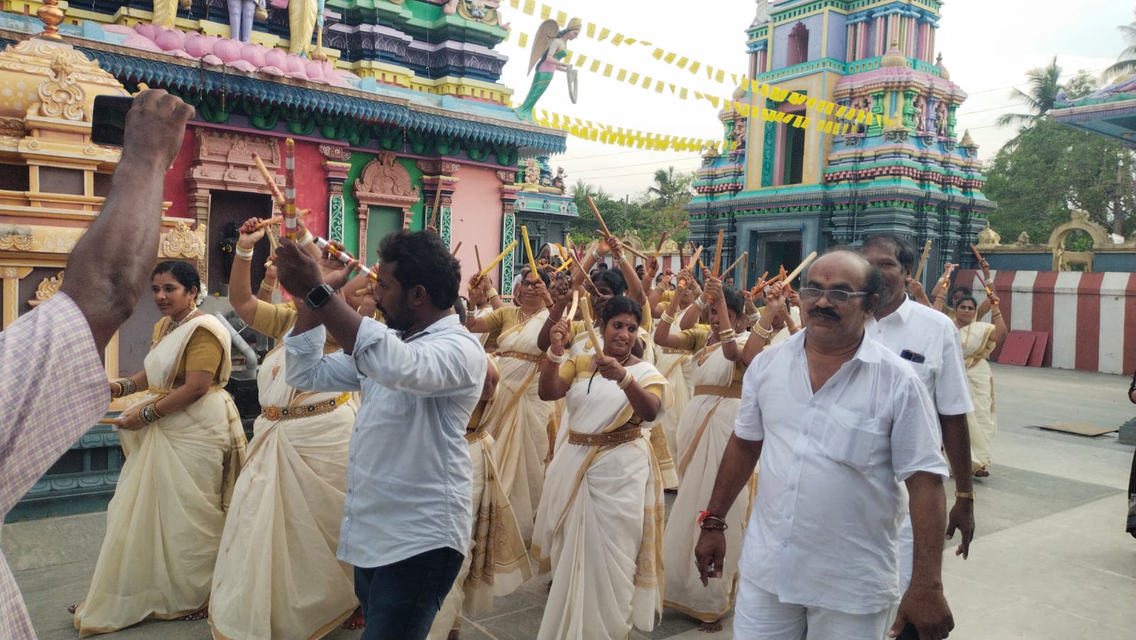 Devotees carrying a ceremonial procession through the temple street